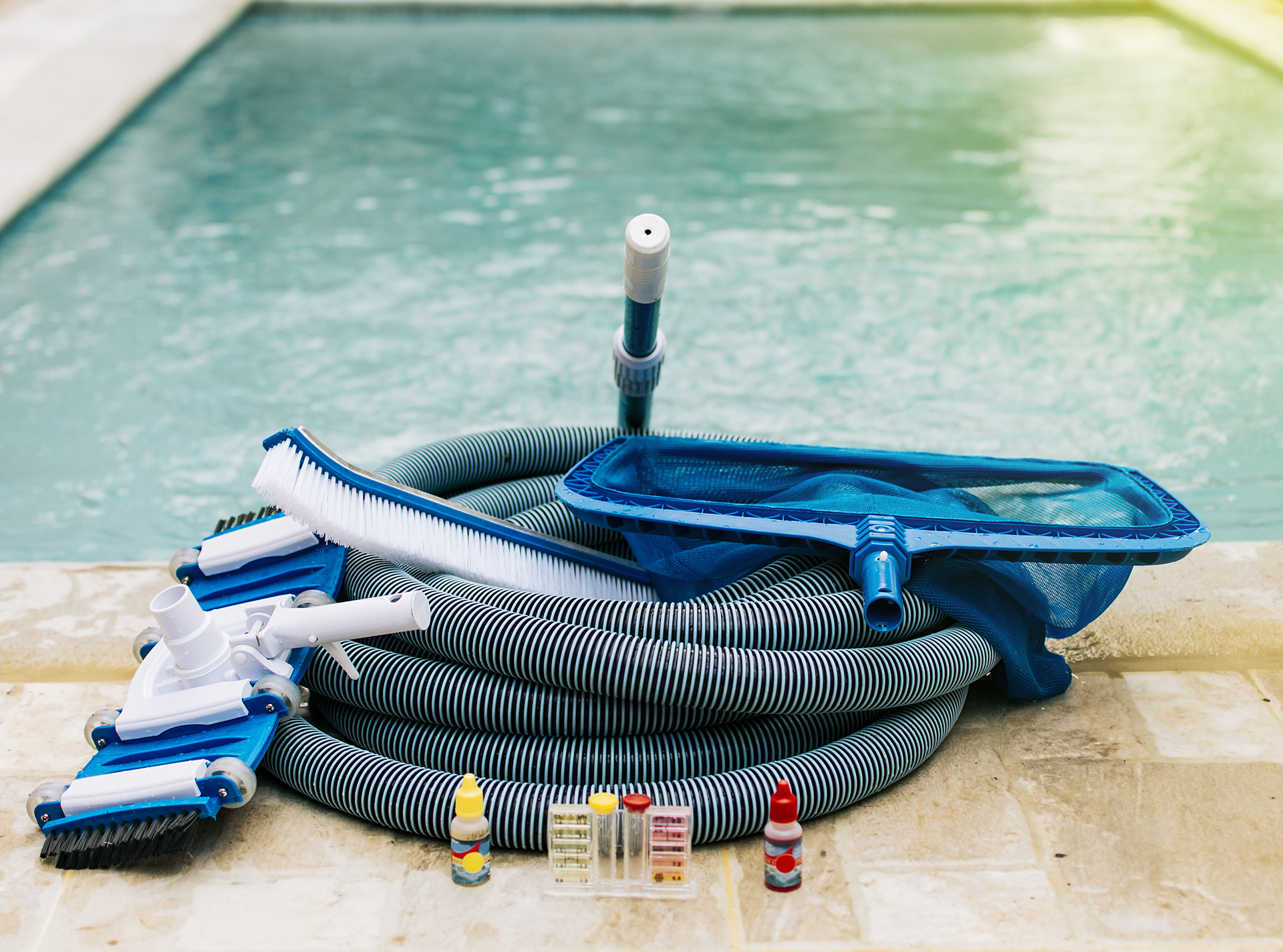 Pool cleaning and maintenance tools, image of pool cleaning and maintenance kit, vacuum cleaner, ph test, leaf picker and pool sweeper